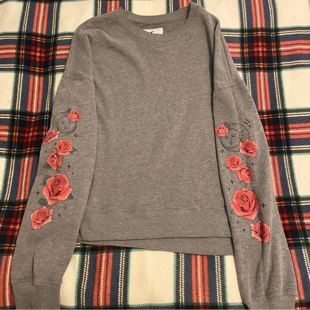 Hollister dark grey crew neck with roses on the sleeves